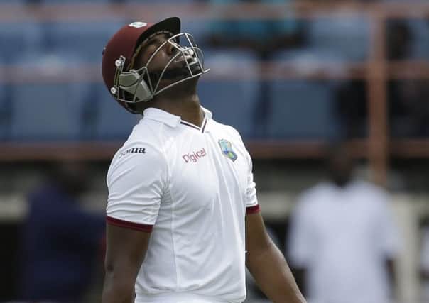 West Indies' Darren Bravo walks towards the pavilion after losing his wicket to Stuart Broad (Picture: Ricardo Mazalan/AP).