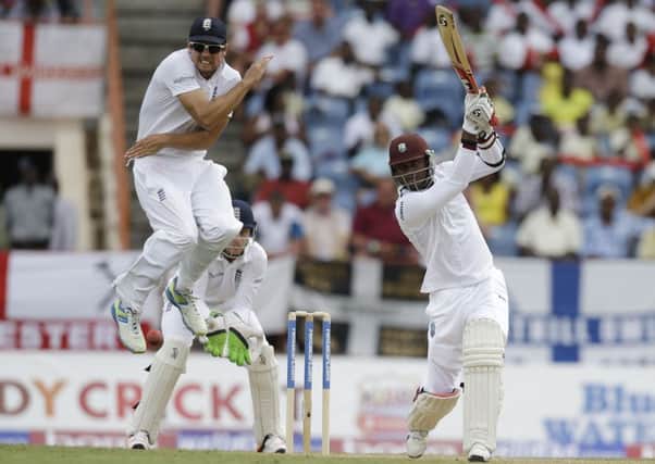 England captain Alistair Cook jumps to avoid being hit by a shot played by West Indies' Marlon Samuels.