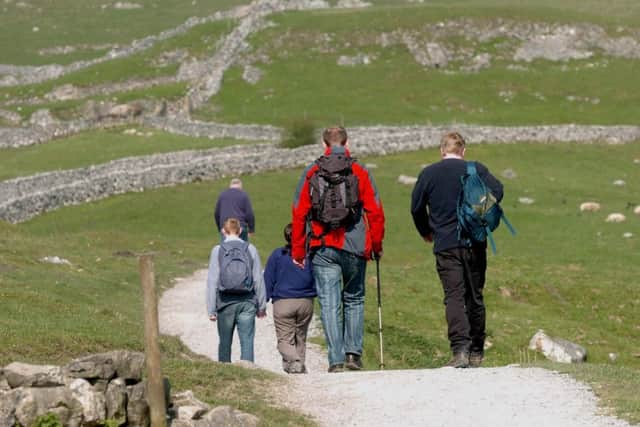 Walkers take a walk on the Pennine Way at Malham Cove as it celebrates its 40th birthday