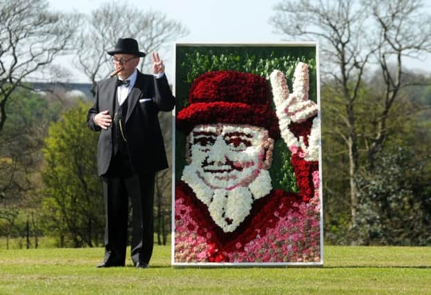 Winston Churchill look-alike Derek Herbert with the flower portrait of the former Prime Minister