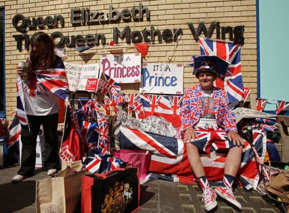 Royal fans wait for the birth of the second child of the Duke and Duchess of Cambridge, outside the Lindo Wing of St. Mary's Hospital in London.