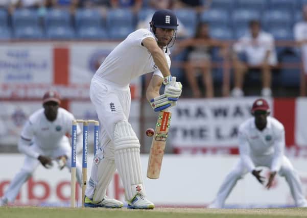 England's captain Alistair Cook plays a shot from the bowling of West Indies' Kemar Roach.