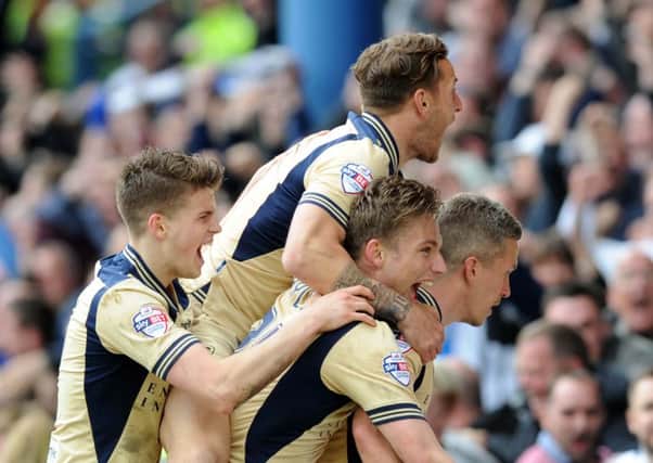 Leeds United striker Steve Morison is mobbed by his team-mates after scoring what proved the winning goal against Sheffield Wednesday at Hillsborough (Picture: Simon Hulme).