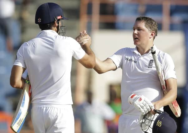 England batsman Gary Ballance, right, shakes hands with team captain Alistair Cook after beating West Indies by nine wickets in Grenada. AP/Ricardo Mazalan.