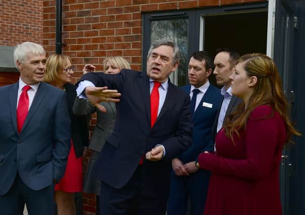 Gordon Brown with labour candidate Harry Harpin and home owner Anne Battersby during his visit to the Shirecliffe area of Sheffield. Picture: Scott Merrylees