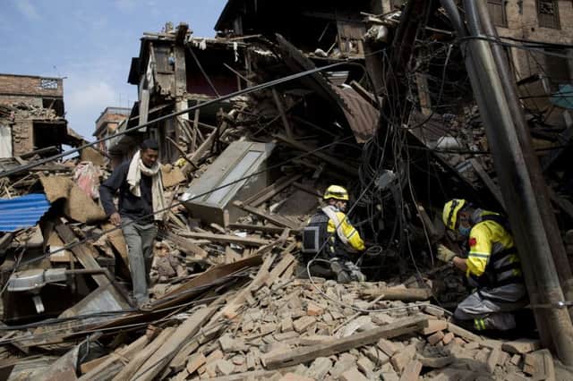 Rescue teams search in debris of collapsed houses after Saturday's earthquake in Bhaktapur, Nepal