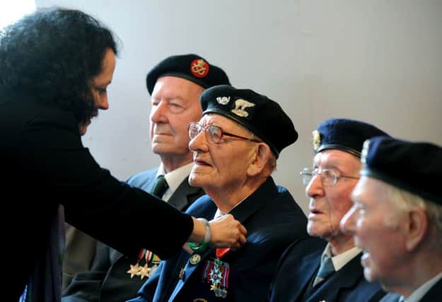 Sylvie Bermann, French Ambassador to Britain, presents a Legion d'Honneur medal to Normandy veteran  Eric Gill, 99, from Mexborough