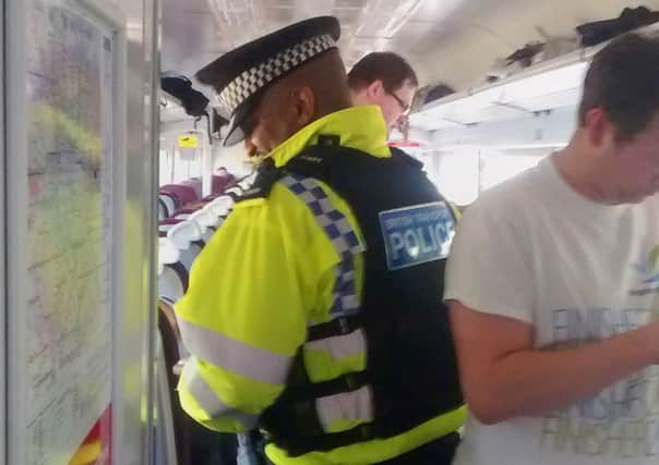 Police on board a crowded Brighton to London service which has been stranded for four hours near Clapham Junction due to a "major power supply problem".