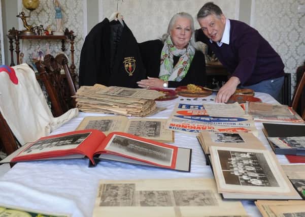 Auctioneer Gary Don with Lynn Eccles, whose uncle, Les White, left a hoard of rugby league memorabilia. 
Picture James Hardisty.