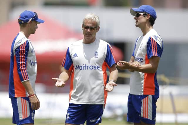 England coach Peter Moores, centre, talks to team captain Allistair Cook, right, and Yorkshire's Joe Root during a field practice at the Kensington Oval. Picture: AP/Ricardo Mazalan.