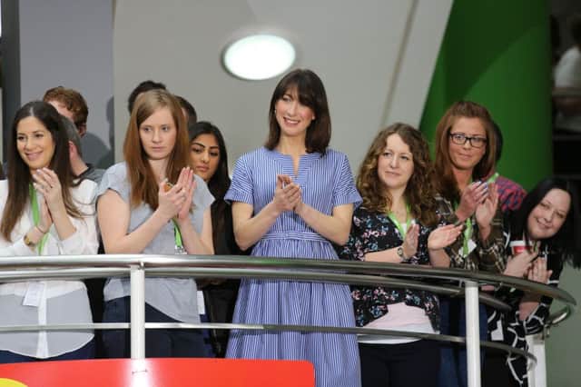 Samantha Cameron watches Prime Minister David Cameron during a PM Direct question and answer session with employees at Asda's head office in Leeds.