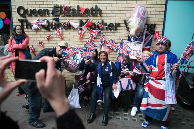 Wellwishers wait and celebrate together outside the Lindo Wing at St Mary's Hospital