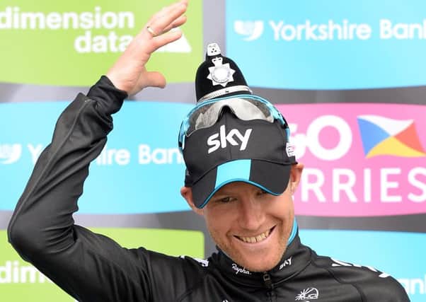 Team Sky Rider Lars-Petter Nordhaug wears a Policeman's helmet trophy after his team won the Team Competition of the Tour de Yorkshire.