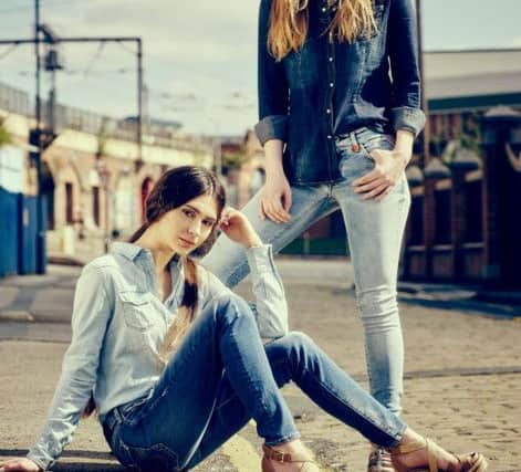 Model sitting wears Replay light wash classic denim shirt, £89.99, and True Religion Halle distressed jeans, £199.99. Model standing wears Replay Luz studded jeans, £134.99, Replay classic denim shirt, as before, from Accent Womenswear in Leeds.