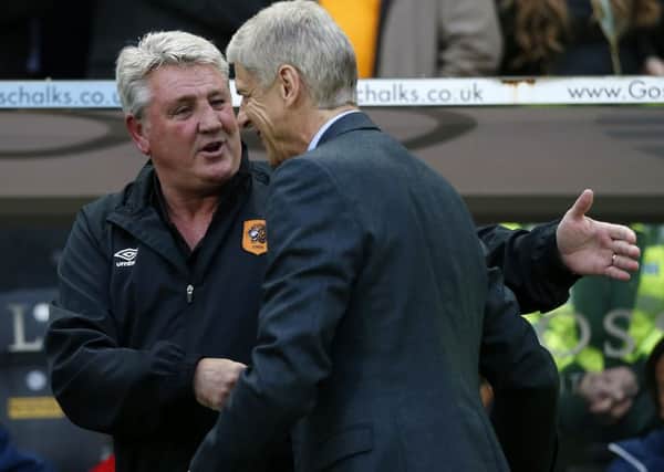 Hull City manager Steve Bruce and Arsenal manager Arsene Wenger (right) before the Barclays Premier League match at the KC Stadium, Hull.