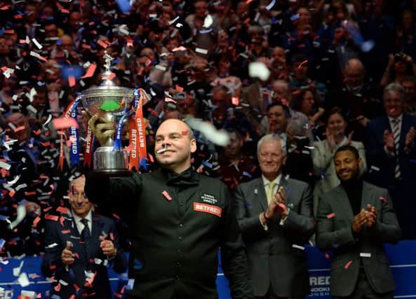 Stuart Bingham celebrates with the World Championships trophy at the Crucible Theatre. Picture: PA.