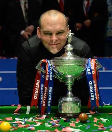 top of the world: Stuart Bingham celebrates with the trophy after defeating Shaun Murphy 18-15 in the final of the World Championship at the Crucible Theatre, Sheffield. Picture: Anna Gowthorpe/PA