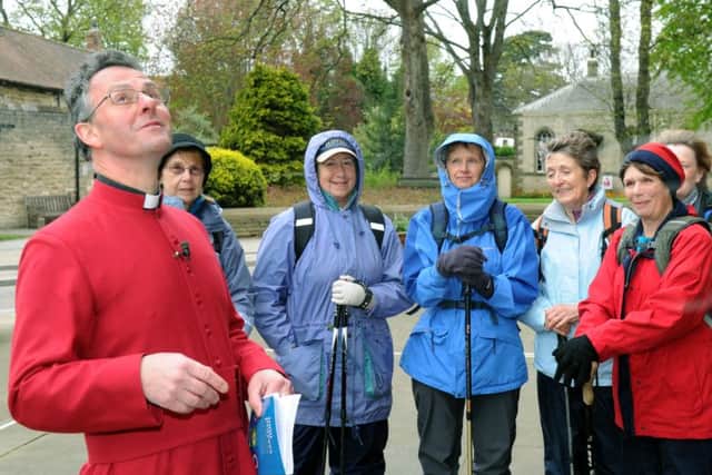 John Dobson, Dean of Ripon, checks the weather  before blessing the  Womens' Institute walkers