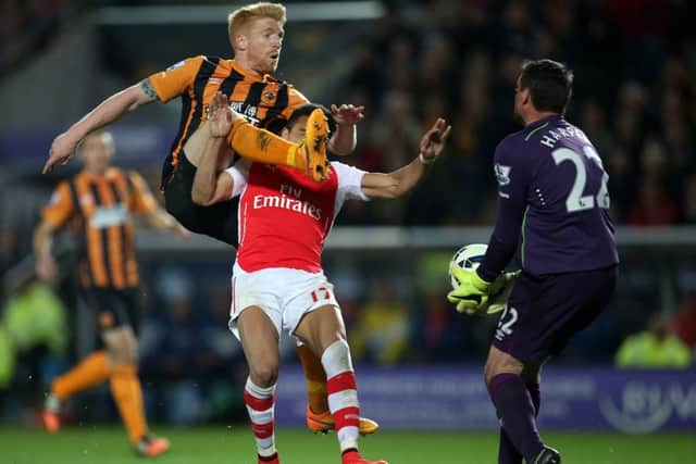 Hull City's Paul McShane battle for the ball with Arsenal's Alexis Sanchez