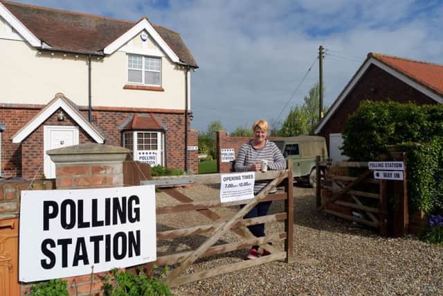Penny Higbee waits to greet voters at her home in Routh, East Yorkshire, which is being used as a rural polling station. Photo: Anna Gowthorpe/PA Wire