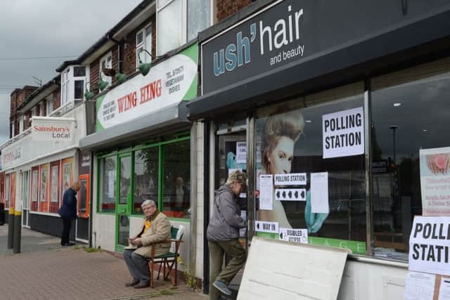 People arrive to vote at Ush Hair studio in Hull which is being used as a polling station, as Britain goes to the ballot box in the most uncertain General Election for decades, with no party on course to emerge a clear winner. PRESS ASSOCIATION Photo. Picture date: Thursday May 7, 2015. See PA story ELECTION Main. Photo credit should read: Anna Gowthorpe/PA Wire