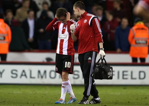 Sheffield United goes off injured with physic Ed Owen. (Picture: Martyn Harrison).