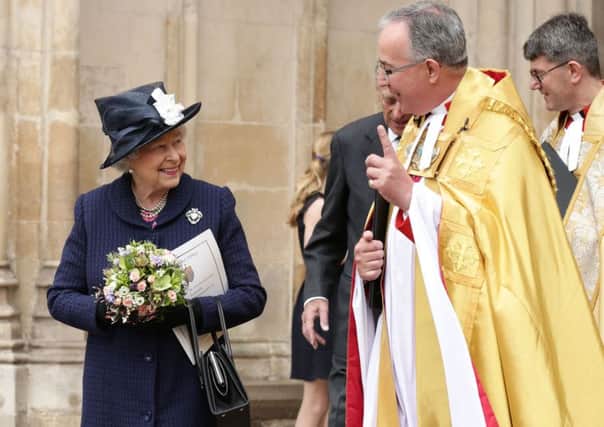 The Queen with the Dean of Westminster, the Very Revd Dr John Hall (right) as she leaves a Service of Thanksgiving . Yui Mok/PA Wire