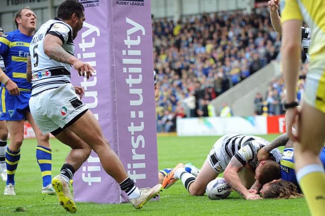 Marc Sneyd forces his way over to score for Hull FC.