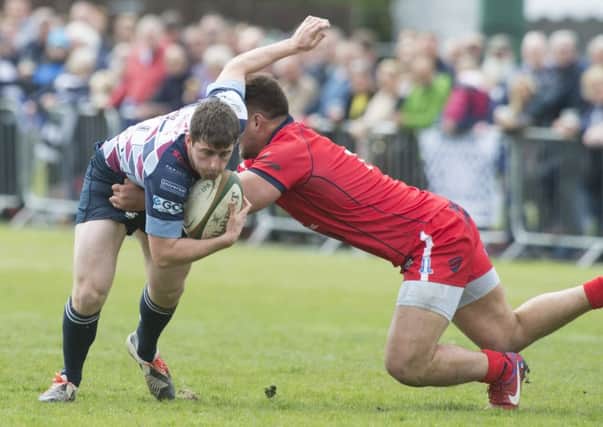 Rotherham's Tom Barrett tries to evade a Jack Lam tackle.
 Picture: Dean Atkins