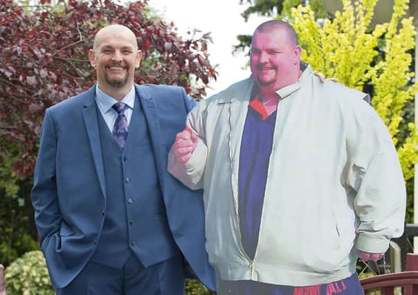 Biscuit factory worker Gary Marsden, 47, during a photocall in central London with a cardboard cutout of his former self, where he was named as Slimming World's Greatest Loser dropped from 37 stone to 18 stone 2015. (PA Wire)
