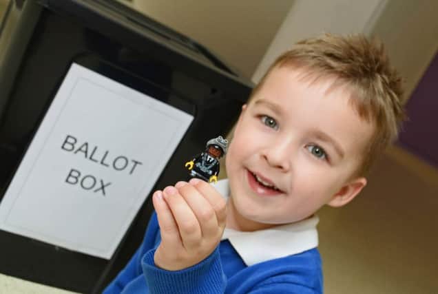 Carter Allen, four, of Scawsby, is reunited with his toy that was dropped in a ballot box. (Picture: Marie Caley)