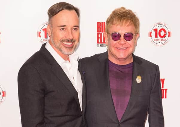 Sir Elton John (right) and his husband David Furnish arriving at the Victoria Palace Theatre, London, as Billy Elliot The Musical celebrates 10 years in the West End. (PA Wire)