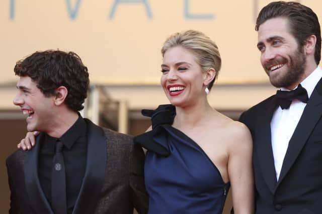 From left, jury members Xavier Dolan, Sienna Miller, and Jake Gyllenhaal pose for photographers as they arrive for the opening ceremony and the screening of the film La Tete Haute (Standing Tall) at the 68th international film festival, Cannes, southern France, Wednesday, May 13, 2015. (AP Photo/Thibault Camus)