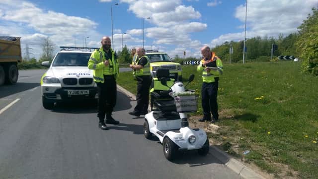 Police officers with the mobility scooter. Pic: Malik Walton