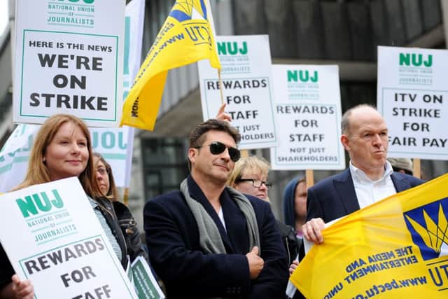 Members of BECTU, the National Union of Journalists and a Simon Cowell lookalike protest outside ITV's AGM at the QEII Centre in London