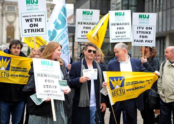 Members of BECTU, the National Union of Journalists and a Simon Cowell lookalike protest outside ITV's AGM at the QEII Centre in London