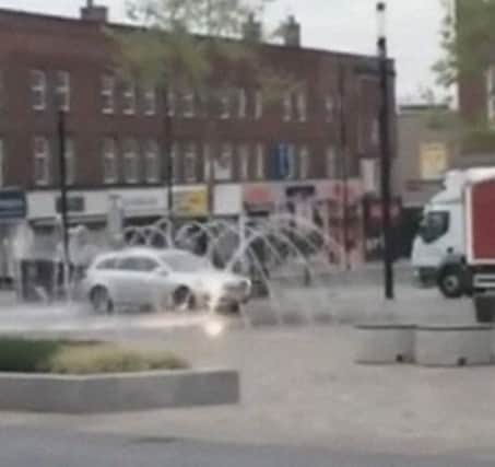 A motorist is chased by police after he took his car for a wash in a fountain. Picture: Ross Parry Agency