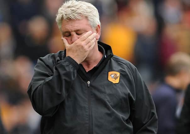 Hull City manager Steve Bruce holds his head during the Barclays Premier League match at the KC Stadium