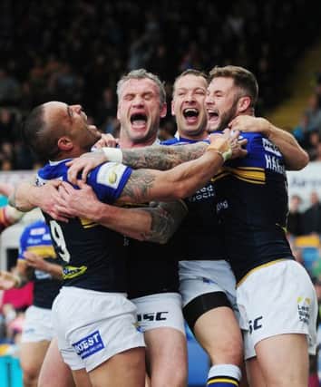 Leeds Rhinos' Jamie Peacock, Danny McGuire and Zak Hardaker congratulate Paul Aiton on his try against Huddersfield. Picture: Steve Riding.