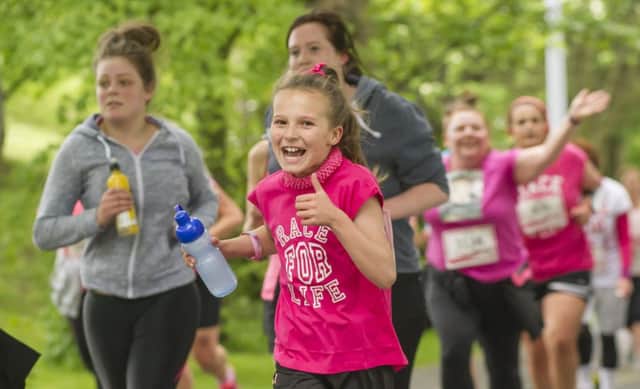 Runners along the route during  the 2015 Wakefield Race For Life.

Picture by Allan McKenzie