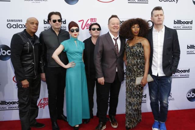 Simple Minds, from left, Mel Gaynor, Andrew Gillespie, Catherine Davies, Charlie Burchill, James Kerr, Sarah Brown, and Gerard Grimes, arrive at the Billboard Music Awards