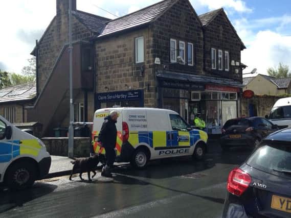 Police cordoned off the post office and the neighouring estate agents