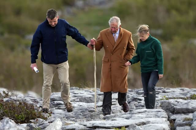 The Prince of Wales is given a tour by Brendan Dunford and Brigid Barry during his visit to the Burren in County Clare, an ancient and dramatic stony outcrop
