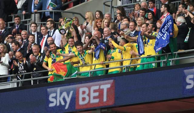 Norwich players celebrate as Richard Flint looks on