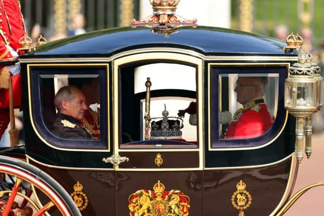 The crown and sceptre are escorted from Buckingham Palace ahead of the State Opening of Parliament.