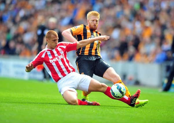 The KC Stadium was the home of top-flight football in 2014-15 for Hull City, with Tigers' defender Paul McShane tackling Stoke's Steve Sidwell in a clash last August, above. Despite Hull's relegation, the KC has come top of the league in a fans' poll