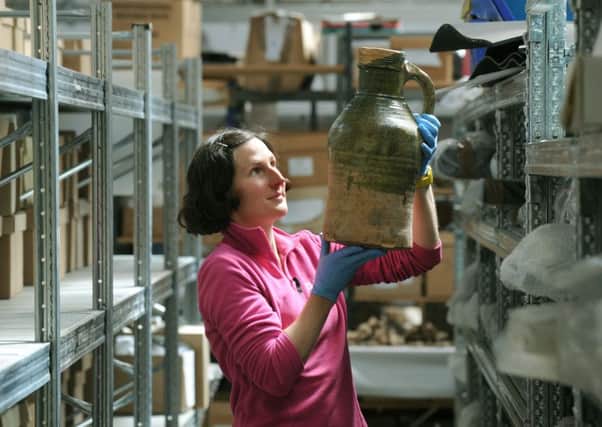 Rachel Cubitt, Collections Officer at the York Archaeological Trust,  with a medieval  Bransby jug