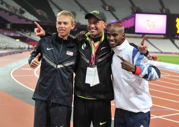 Mo Farah, right, pictured celebrating is Olympic gold medal success in the men's 10,000m final in 2012 with silver medallist Galen Rupp, left, and their coach Alberto Salazar (Picture: Martin Rickett/PA Wire).