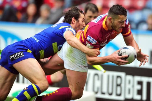 Giants' Jake Connor is tackled by Wolves' Stefan Ratchford.