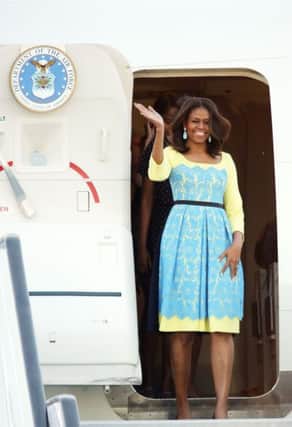 US first lady Michelle Obama waves as she arrives at Stansted Airport, Essex, for a visit to the UK,.